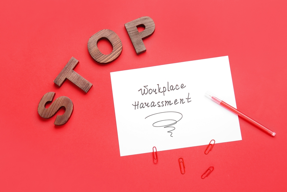 Text,Stop,Workplace,Harassment,With,Stationery,On,Color,Background