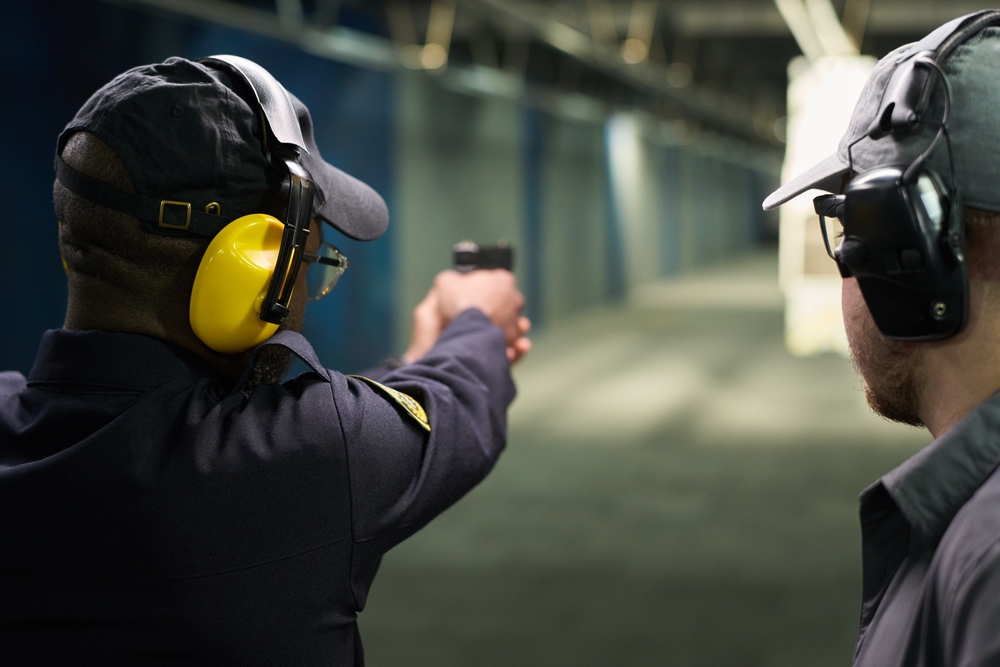 Person,Practicing,Shooting,At,Indoor,Shooting,Range,With,Handgun,While