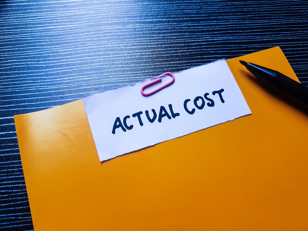 Actual,Cost,Writting,On,Table,Background.